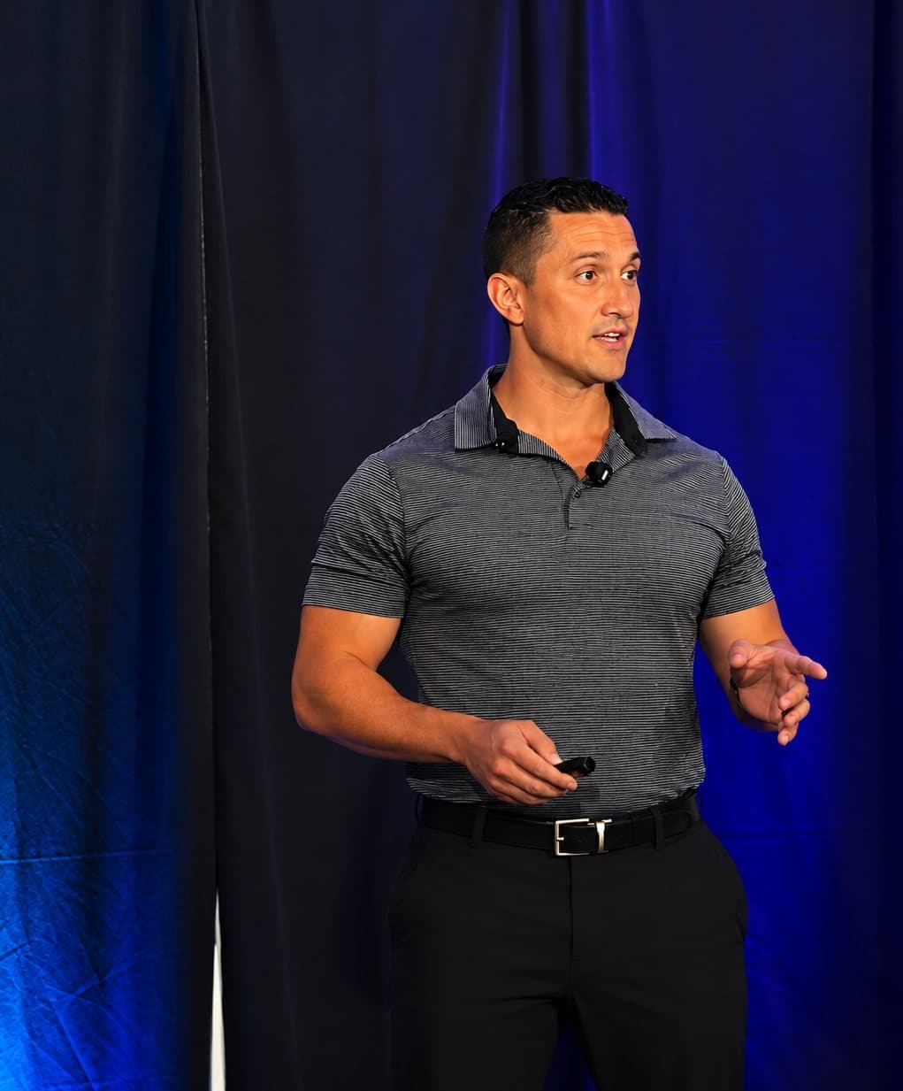 Tom Leonardis speaking on stage at a fitness business event